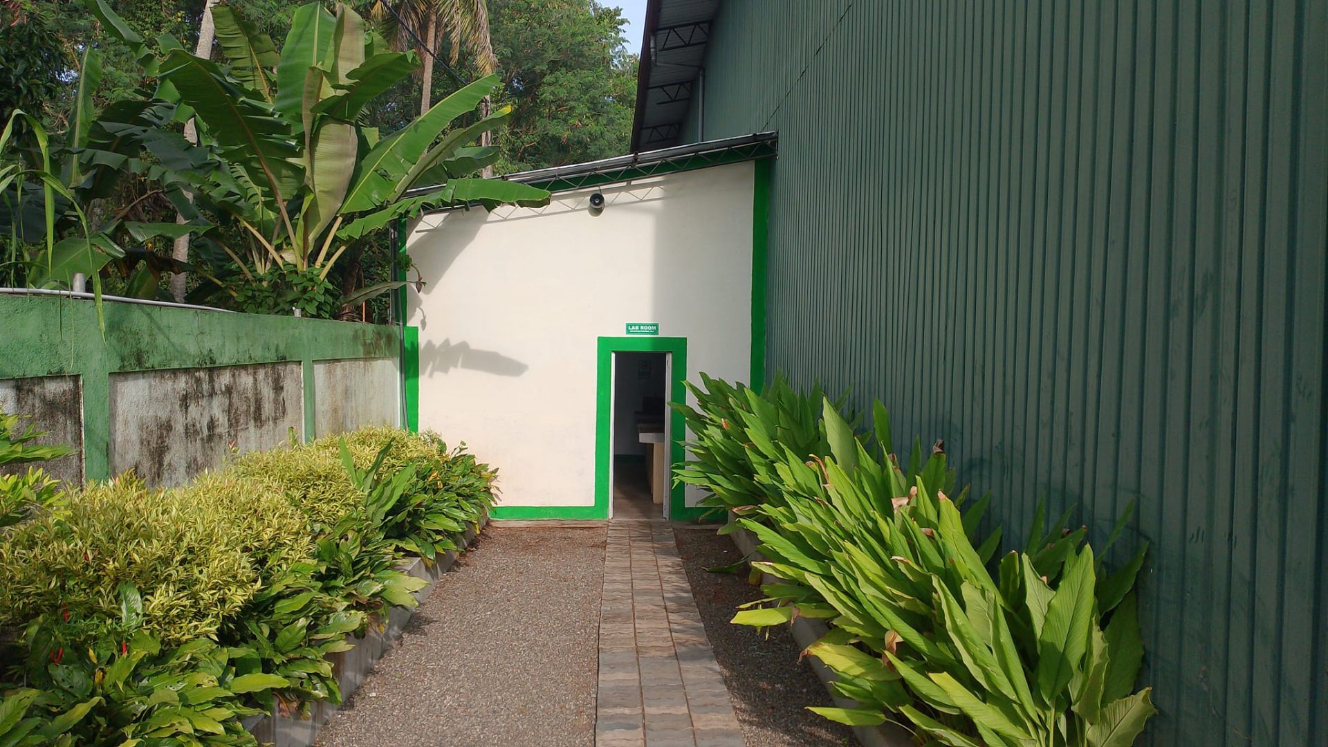 Modern facility entrance with green landscaping